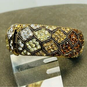 Cuff bracelet with a honeycomb pattern and amber-colored rhinestones